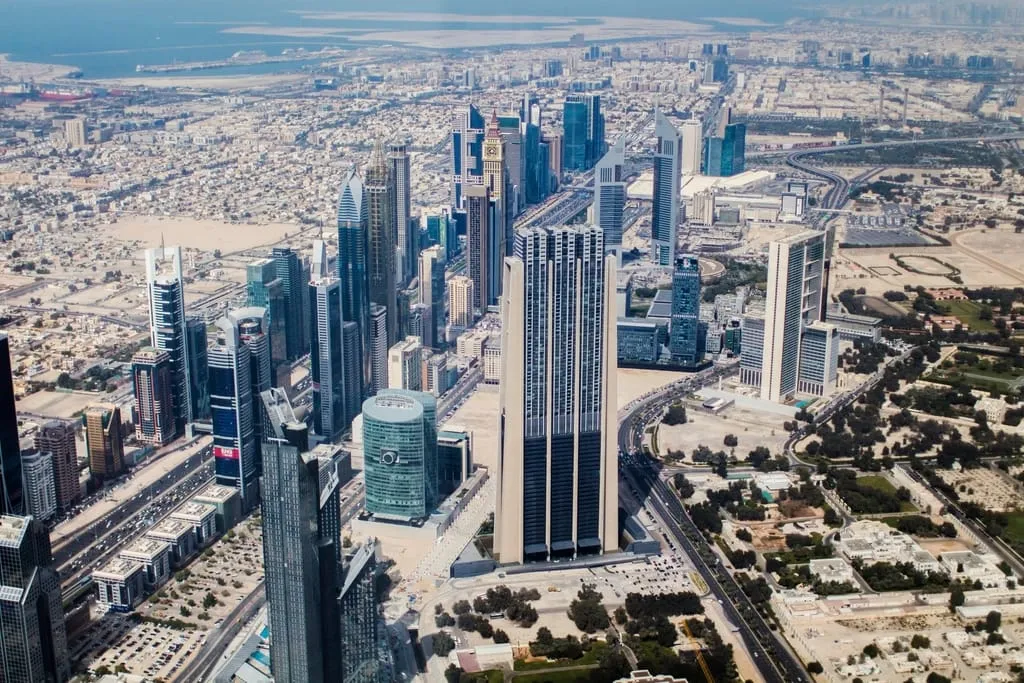 An aerial view over the Dubai skyline and coastline